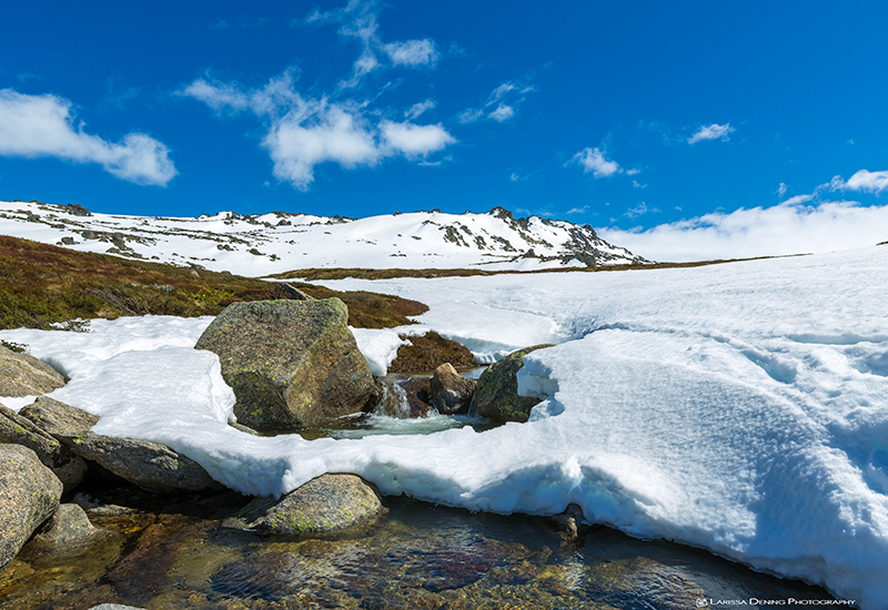 A mini waterfalls as the snow begins to melt in the sun, Snowy Mountains, Australia